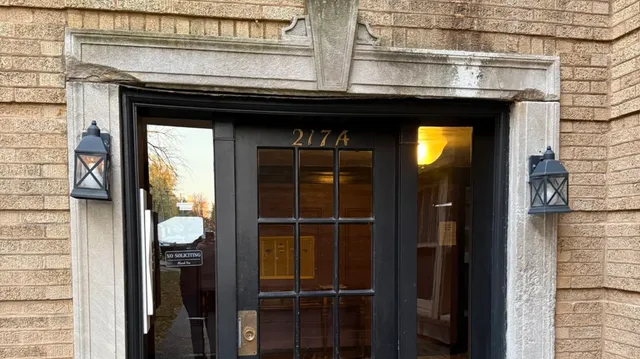 a view of a wooden door and a front door