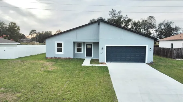 a front view of house with yard and trees