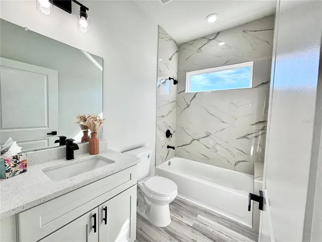a bathroom with a sink a toilet and a bathtub