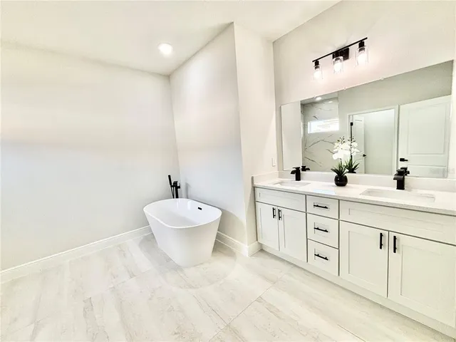 a bathroom with a double vanity sink mirror and toilet