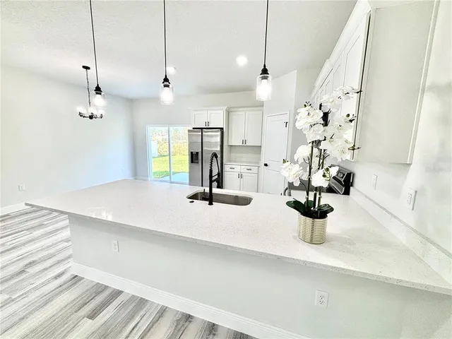a view of dining room and kitchen with a sink