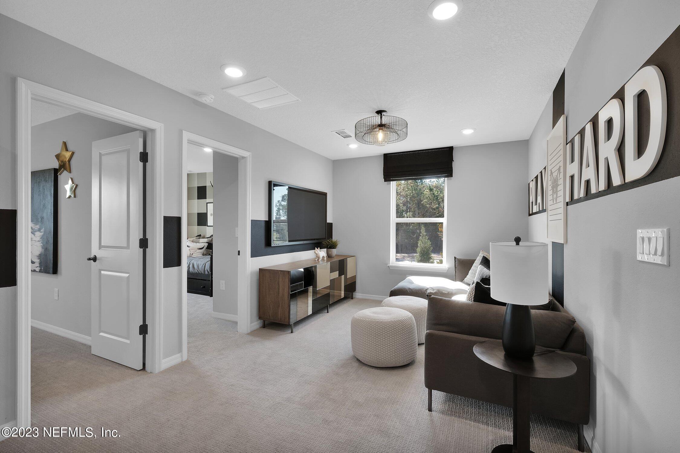 731 Blind Oak Circle St. Augustine, FL 32095 - Photo 14 of 34 a living room with furniture and a flat screen tv