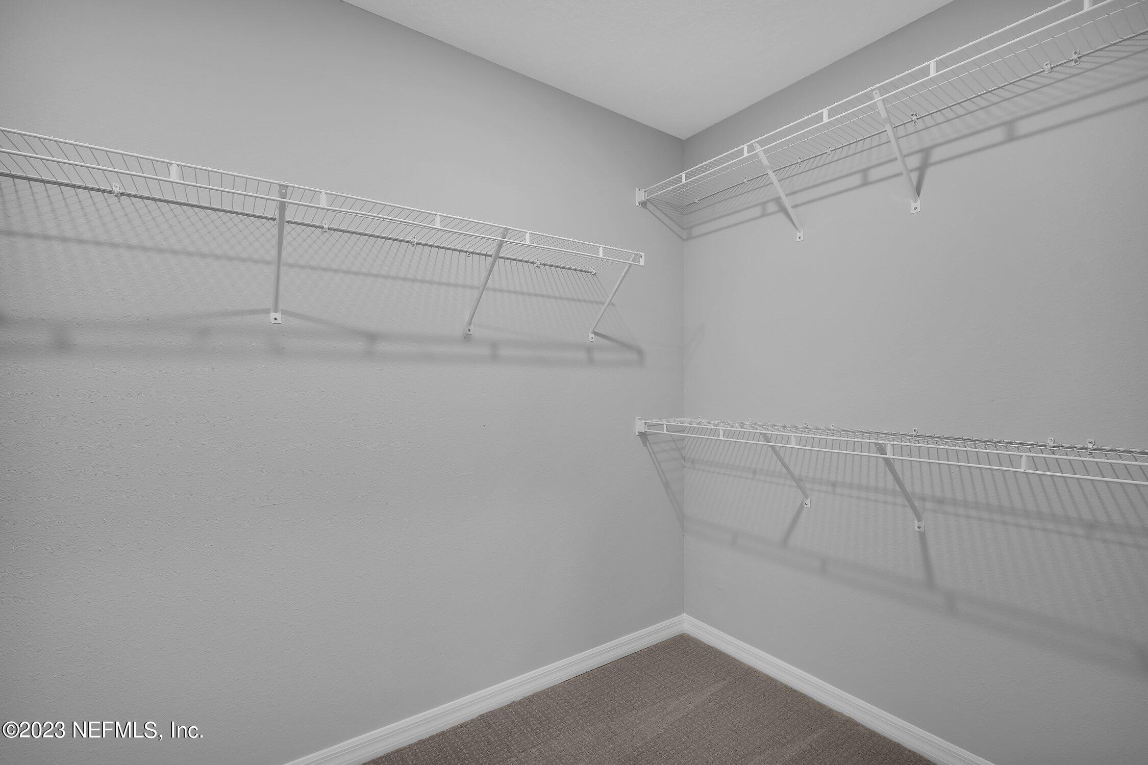 731 Blind Oak Circle St. Augustine, FL 32095 - Photo 19 of 34 a view of a room with racks on the wall