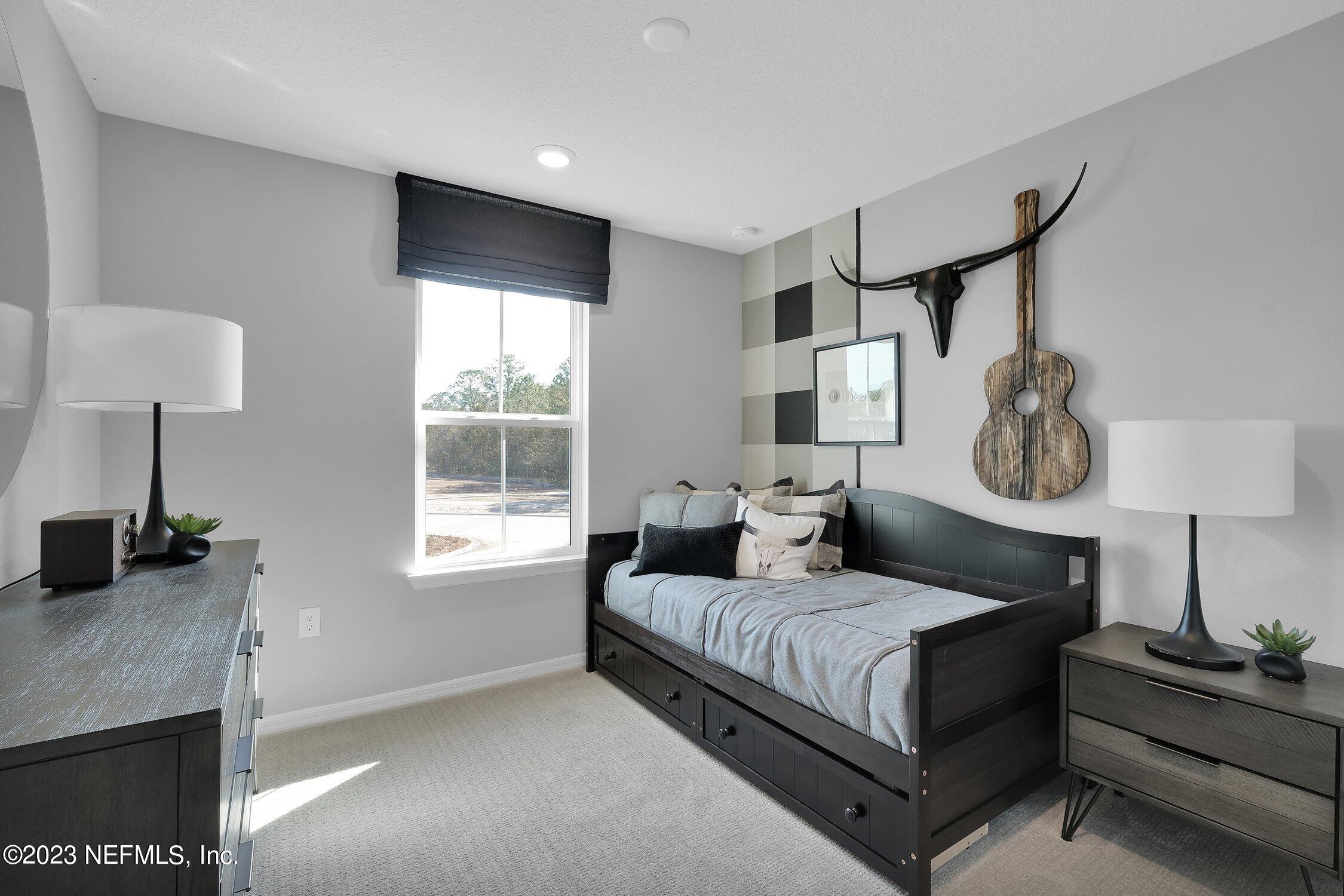 731 Blind Oak Circle St. Augustine, FL 32095 - Photo 22 of 34 a bedroom with a bed and a window