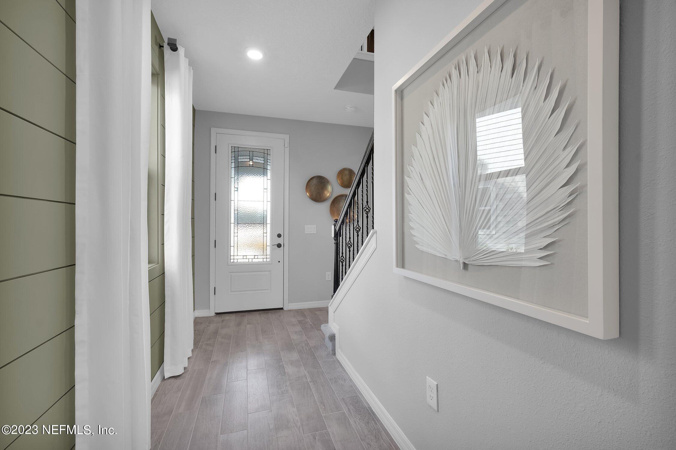 731 Blind Oak Circle St. Augustine, FL 32095 - Photo 4 of 34 a view of a hallway view with wooden floor and staircase