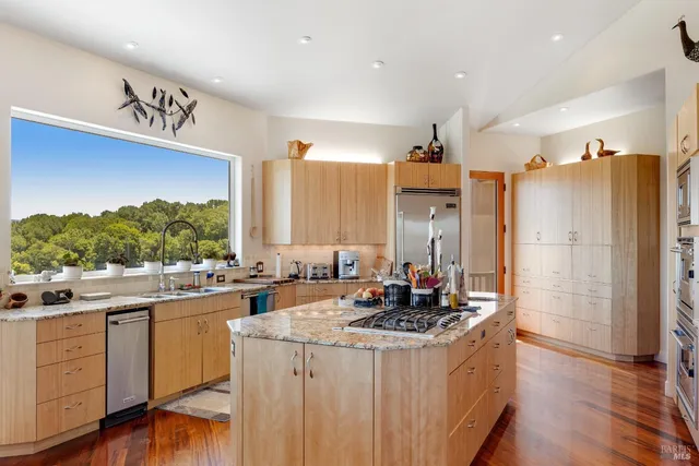 a bathroom with a tub a sink and a large mirror
