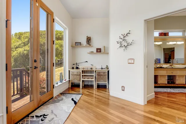 a front view of a house with a yard and covered with flower plants
