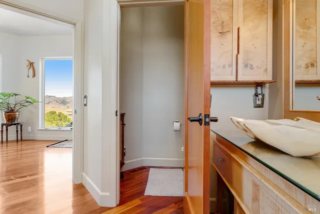 a view of a patio with table and chairs with wooden floor and fence