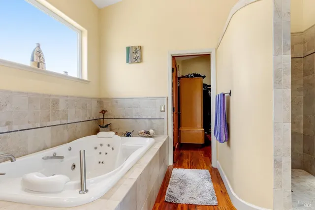 a kitchen with stainless steel appliances kitchen island granite countertop a refrigerator and cabinets