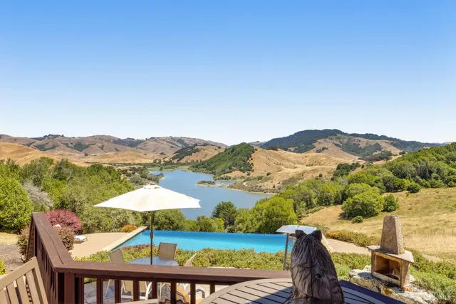 a view of a garden with a house in the background