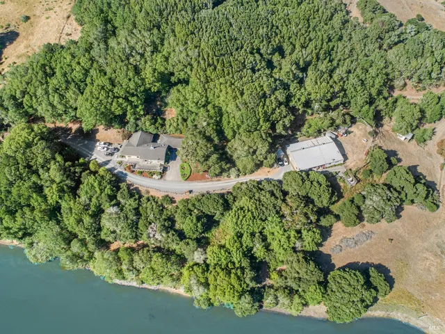 a living room with furniture a rug and a floor to ceiling window