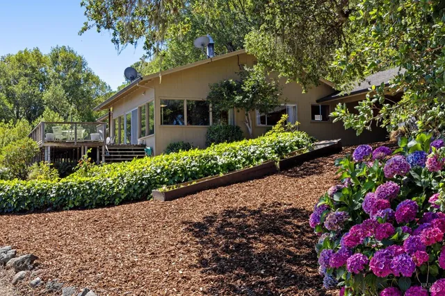 a bedroom with furniture and a large window
