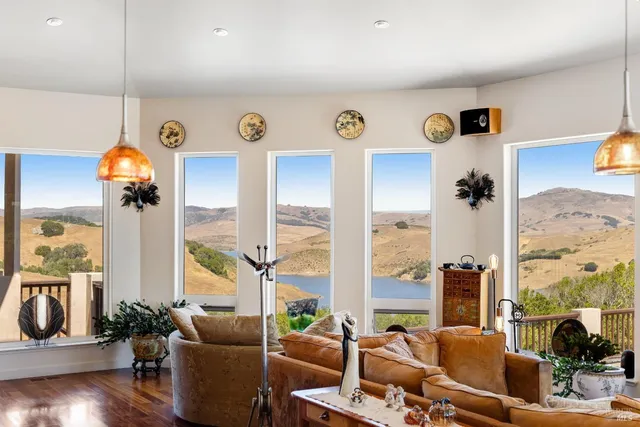 a living room with lots of furniture and a large window