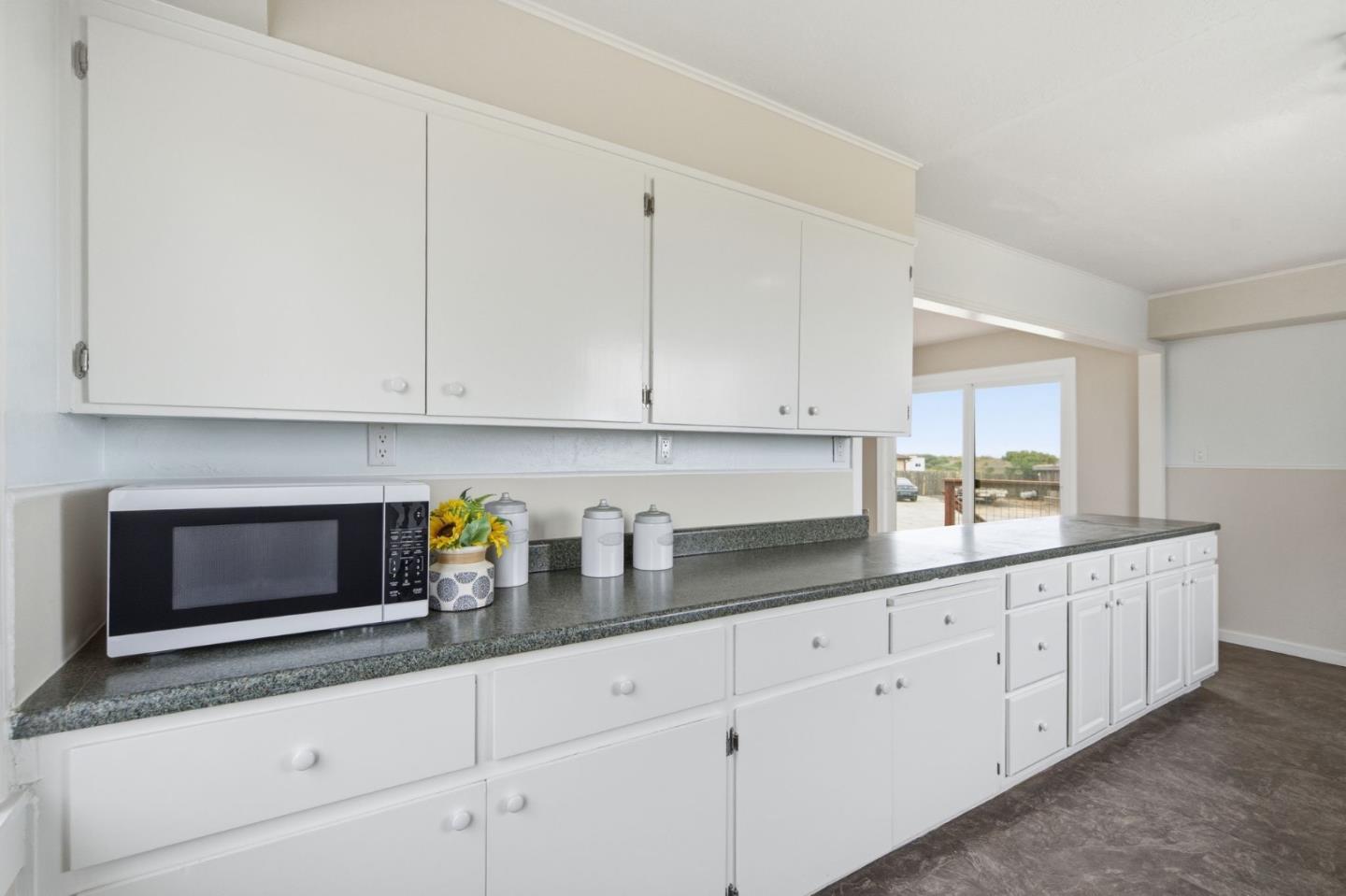 1263 Reservoir Road Pescadero, CA 94060 - Photo 18 of 66 a kitchen with stainless steel appliances granite countertop white cabinets and a sink