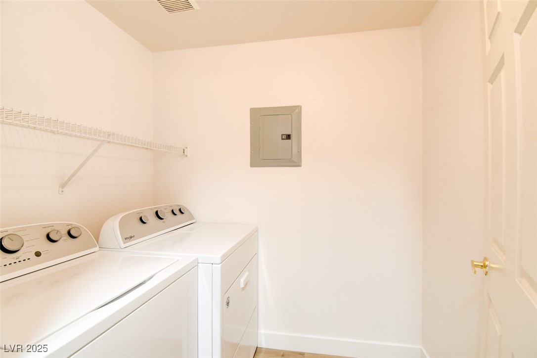 7115 South Durango Drive, Unit 207 Las Vegas, NV 89113 - Photo 10 of 34 Laundry area with electric panel and washing machine and dryer