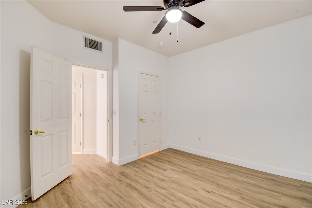 7115 South Durango Drive, Unit 207 Las Vegas, NV 89113 - Photo 12 of 34 Unfurnished bedroom featuring light wood-style flooring and ceiling fan