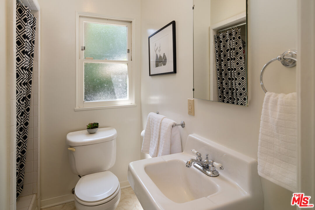 1422 Maple Street South Pasadena, CA 91030 - Photo 28 of 45 a bathroom with a toilet a sink and a mirror