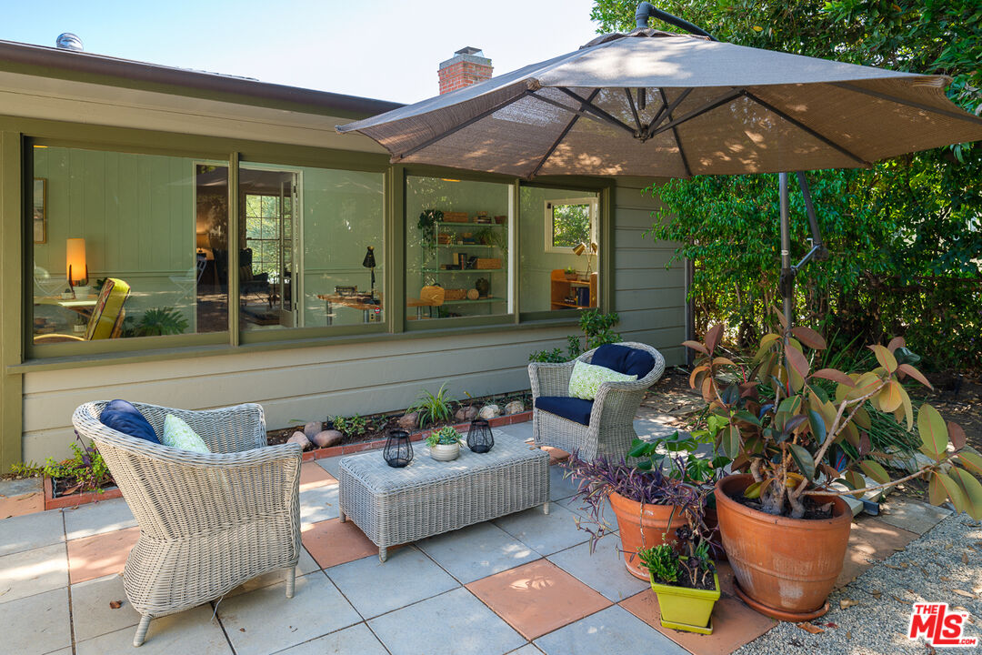 1422 Maple Street South Pasadena, CA 91030 - Photo 35 of 45 a patio with a table and chairs under an umbrella