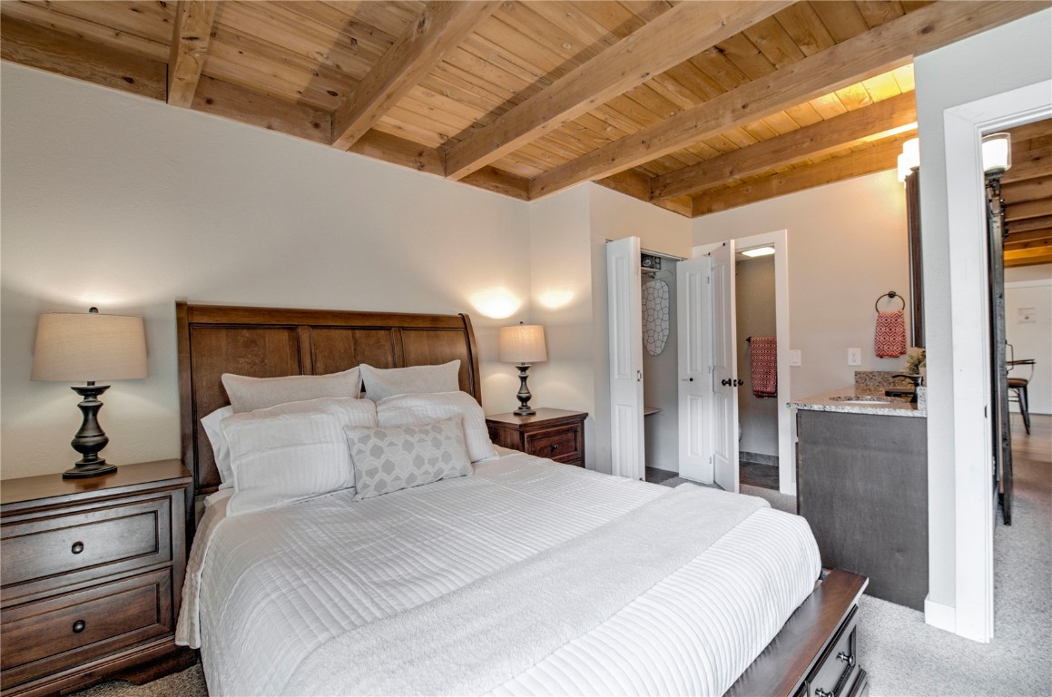 8500 Ryan Gulch Road, Unit G3 Silverthorne, CO 80498 - Photo 11 of 28 a bedroom with a bed and a large mirror