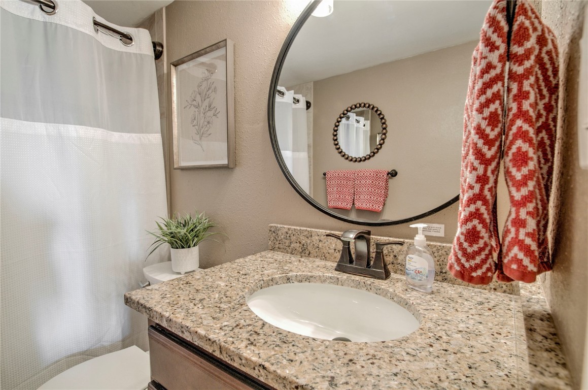 8500 Ryan Gulch Road, Unit G3 Silverthorne, CO 80498 - Photo 13 of 28 a bathroom with a granite countertop sink and a mirror