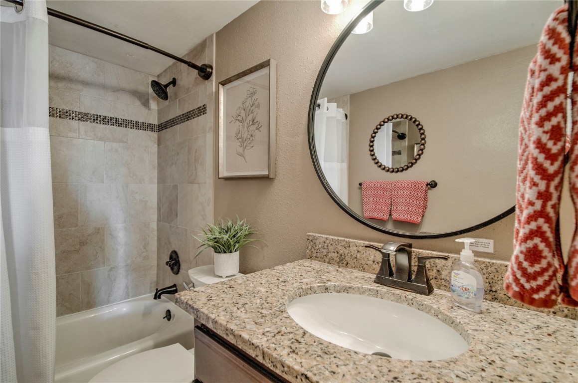 8500 Ryan Gulch Road, Unit G3 Silverthorne, CO 80498 - Photo 14 of 28 a bathroom with a granite countertop sink mirror and vanity