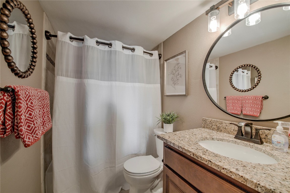 8500 Ryan Gulch Road, Unit G3 Silverthorne, CO 80498 - Photo 16 of 28 a bathroom with a granite countertop sink mirror vanity and toilet