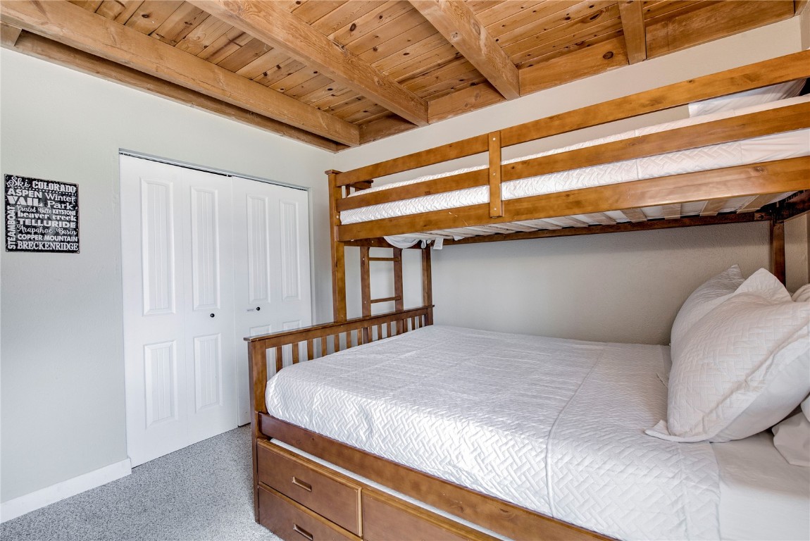 8500 Ryan Gulch Road, Unit G3 Silverthorne, CO 80498 - Photo 19 of 28 a bedroom with a bed and a cabinets