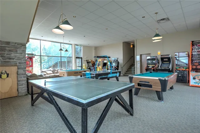 a room with gym equipment and pool table