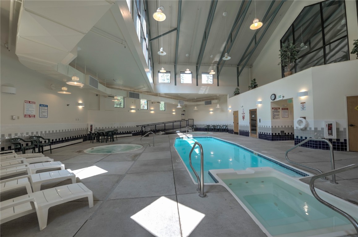 8500 Ryan Gulch Road, Unit G3 Silverthorne, CO 80498 - Photo 25 of 28 a large room with lots of chairs and a chandelier