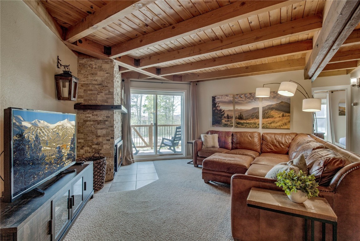 8500 Ryan Gulch Road, Unit G3 Silverthorne, CO 80498 - Photo 3 of 28 a living room with furniture and a flat screen tv