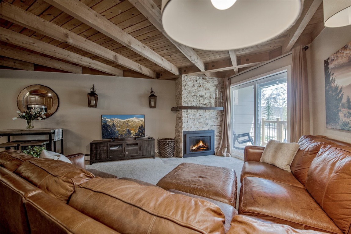 8500 Ryan Gulch Road, Unit G3 Silverthorne, CO 80498 - Photo 4 of 28 a living room with furniture a fireplace and a large window