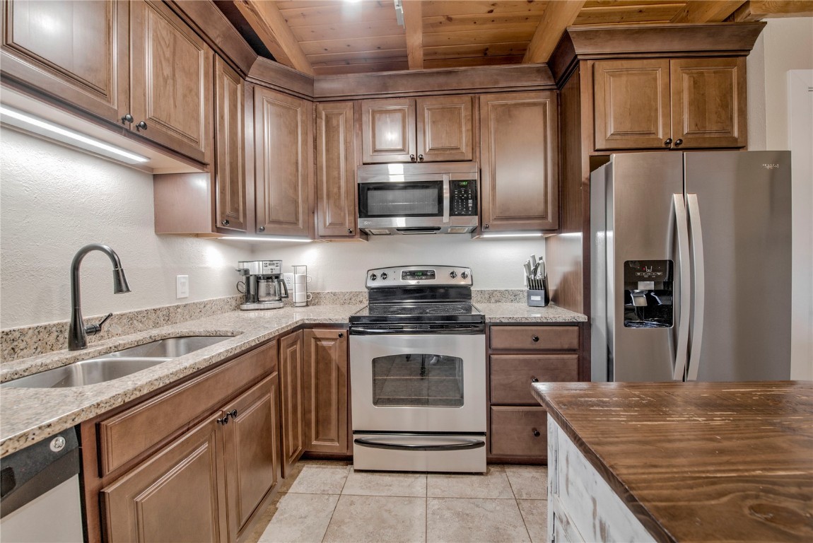 8500 Ryan Gulch Road, Unit G3 Silverthorne, CO 80498 - Photo 8 of 28 a kitchen with a sink stove and refrigerator