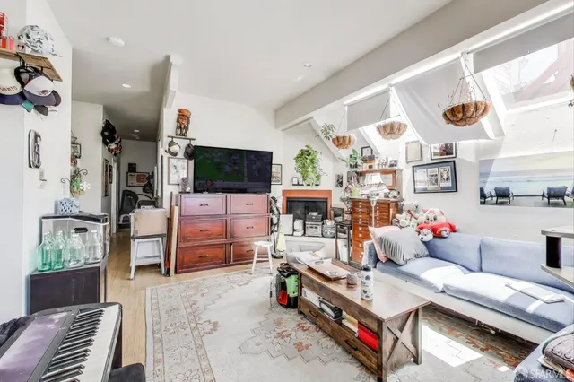 a kitchen with white cabinets and wooden floor