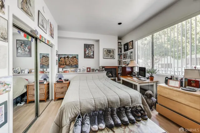 a kitchen with stainless steel appliances cabinets and a wooden floor