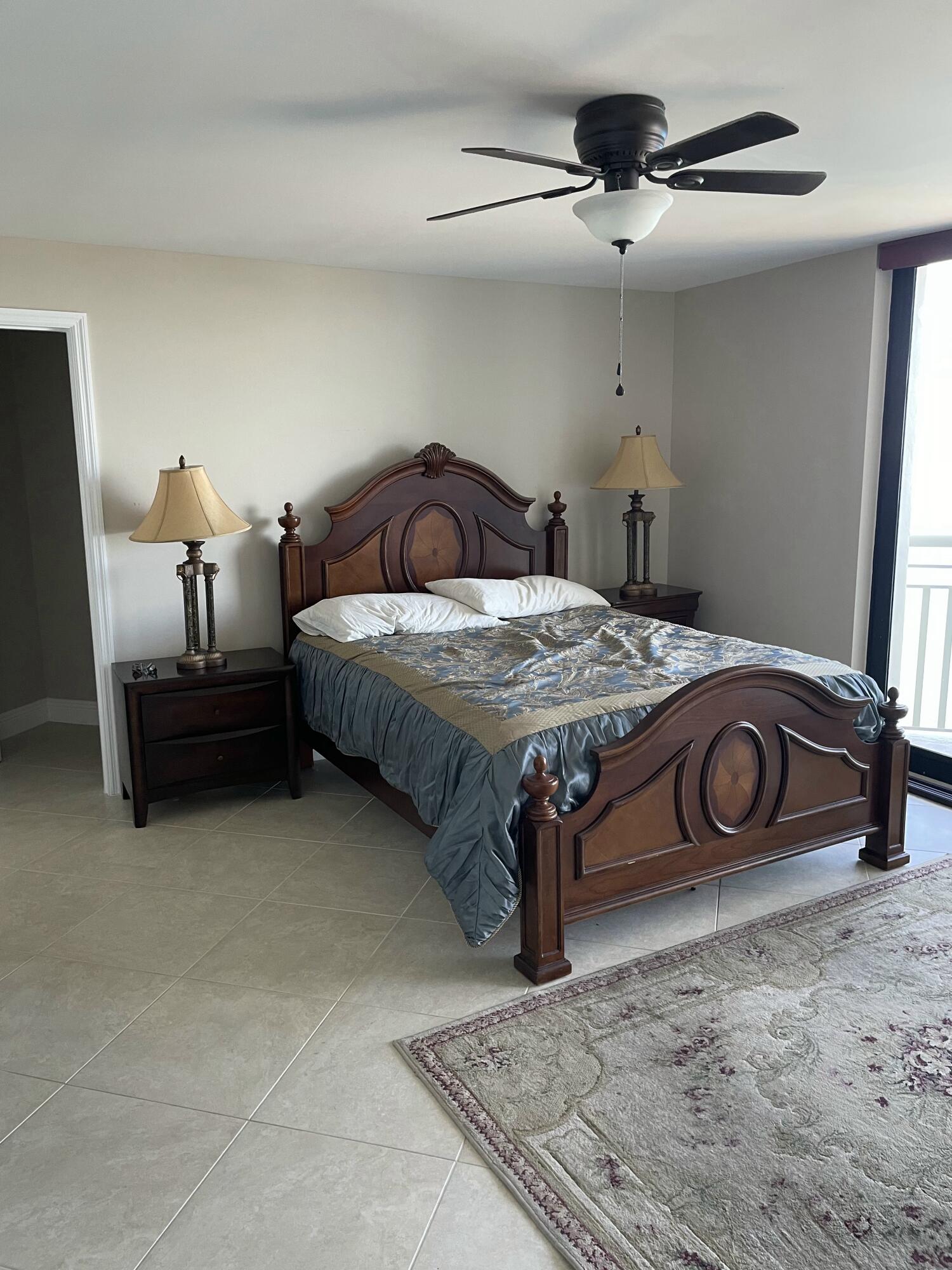 3000 North Ocean Drive, Unit 36C Riviera Beach, FL 33404 - Photo 5 of 18 a bedroom with a bed and a chandelier