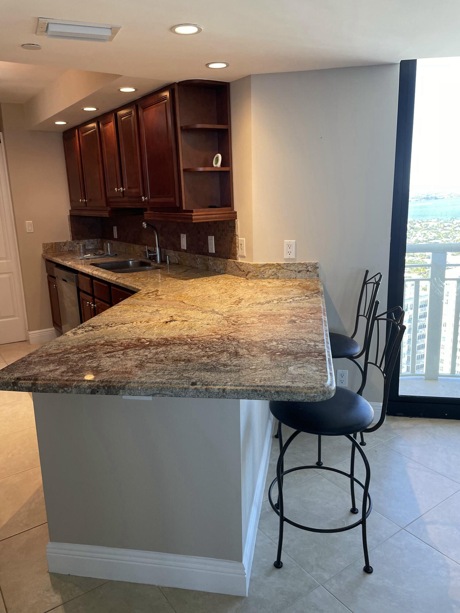 3000 North Ocean Drive, Unit 36C Riviera Beach, FL 33404 - Photo 10 of 18 a view of kitchen island with wooden floor