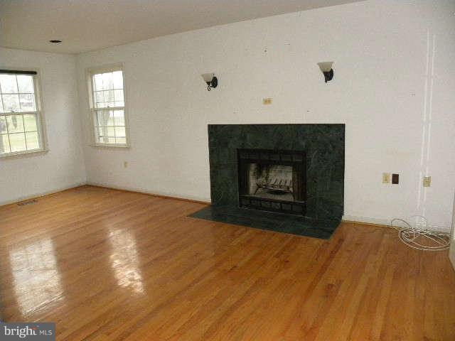 1108 Meredith Lane Davidsonville, MD 21035 - Photo 14 of 24 a view of empty room with wooden floor and fireplace