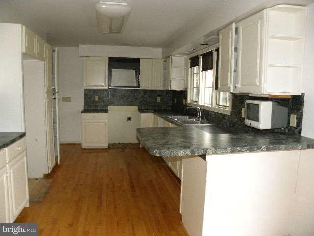 1108 Meredith Lane Davidsonville, MD 21035 - Photo 9 of 24 a kitchen with granite countertop a sink stove and cabinets