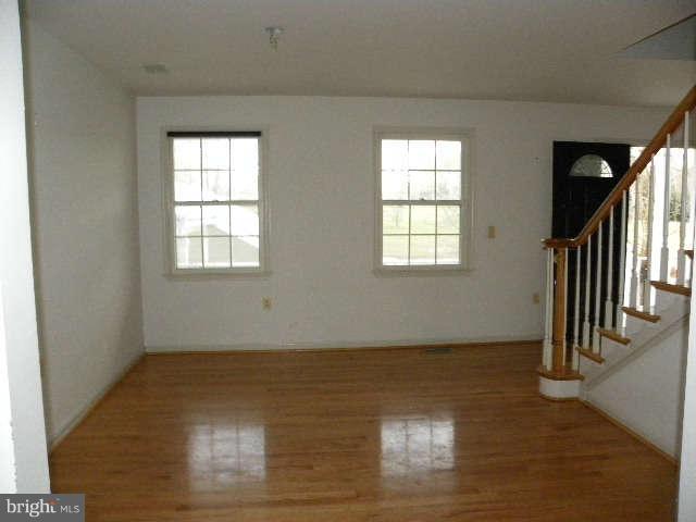 1108 Meredith Lane Davidsonville, MD 21035 - Photo 10 of 24 an empty room with wooden floor and windows