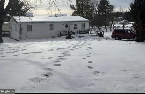a view of a house with a yard covered in snow