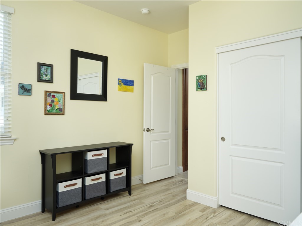 1156 Saltillo Way Nipomo, CA 93444 - Photo 13 of 29 a view of a hallway with wooden floor and furniture