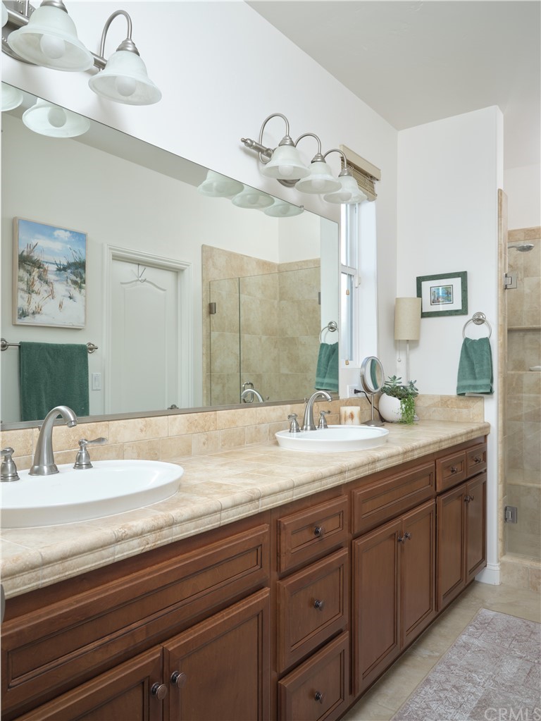 1156 Saltillo Way Nipomo, CA 93444 - Photo 9 of 29 a bathroom with a granite countertop sink and a mirror