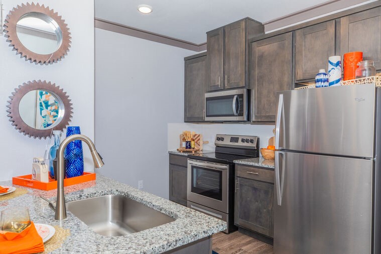 9393 Fm 1960 Bypass Road West, Unit 2113 Humble, TX 77338 - Photo 8 of 28 a kitchen with stainless steel appliances granite countertop a sink a stove a refrigerator and a microwave