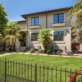a front view of a house with a yard table and chairs
