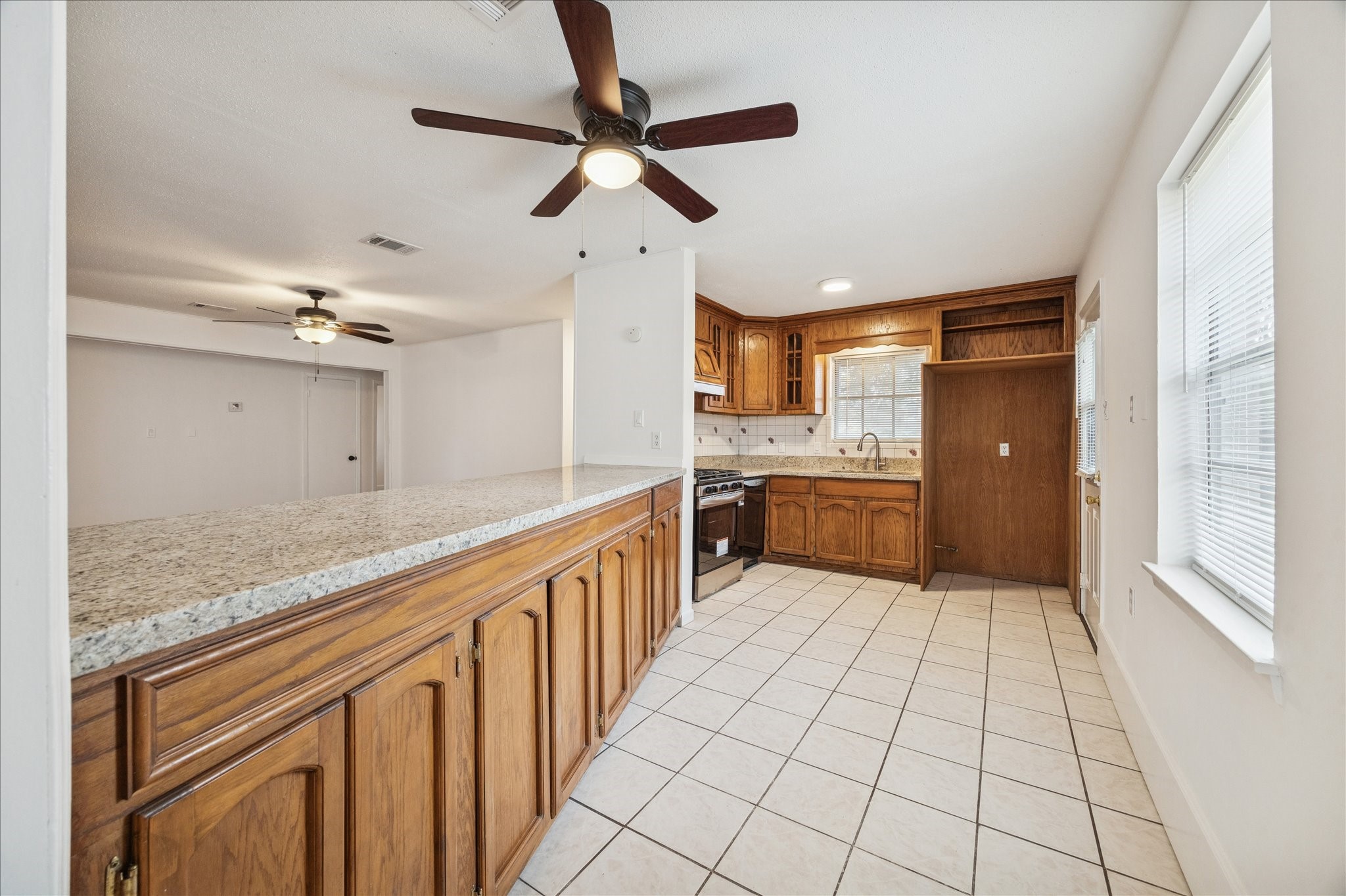 431 Hummingbird Lane Houston, TX 77060 - Photo 7 of 22 a large kitchen with stainless steel appliances kitchen island granite countertop a refrigerator and a sink
