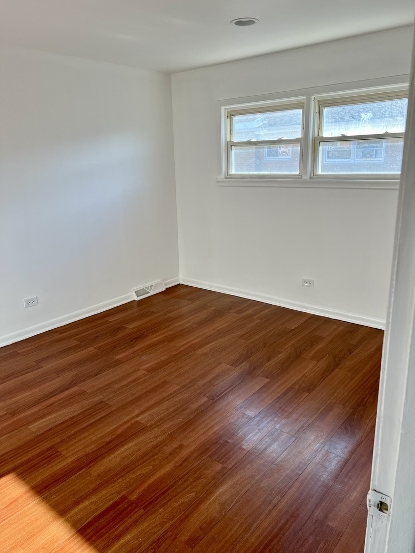 9559 Sumac Road, Unit F Des Plaines, IL 60016 - Photo 12 of 24 a view of empty room with wooden floor