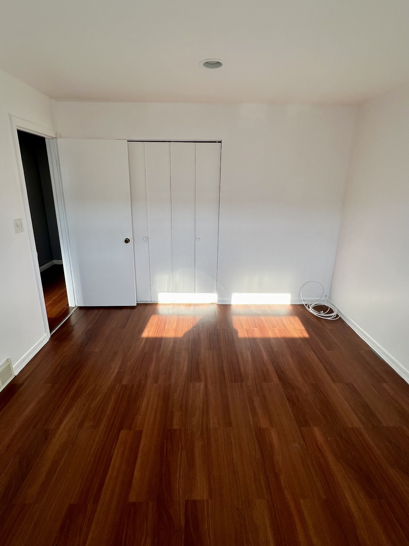 9559 Sumac Road, Unit F Des Plaines, IL 60016 - Photo 13 of 24 a view of a room with wooden floor