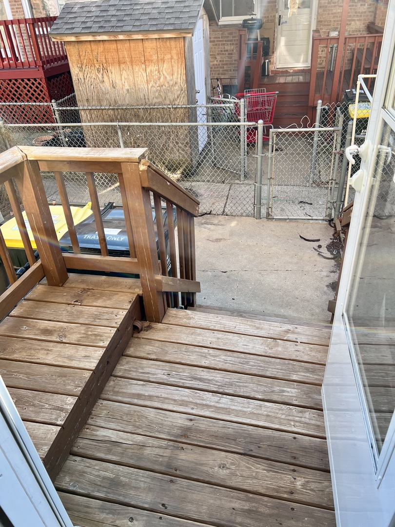 9559 Sumac Road, Unit F Des Plaines, IL 60016 - Photo 22 of 24 a view of a balcony with wooden floor and iron stairs