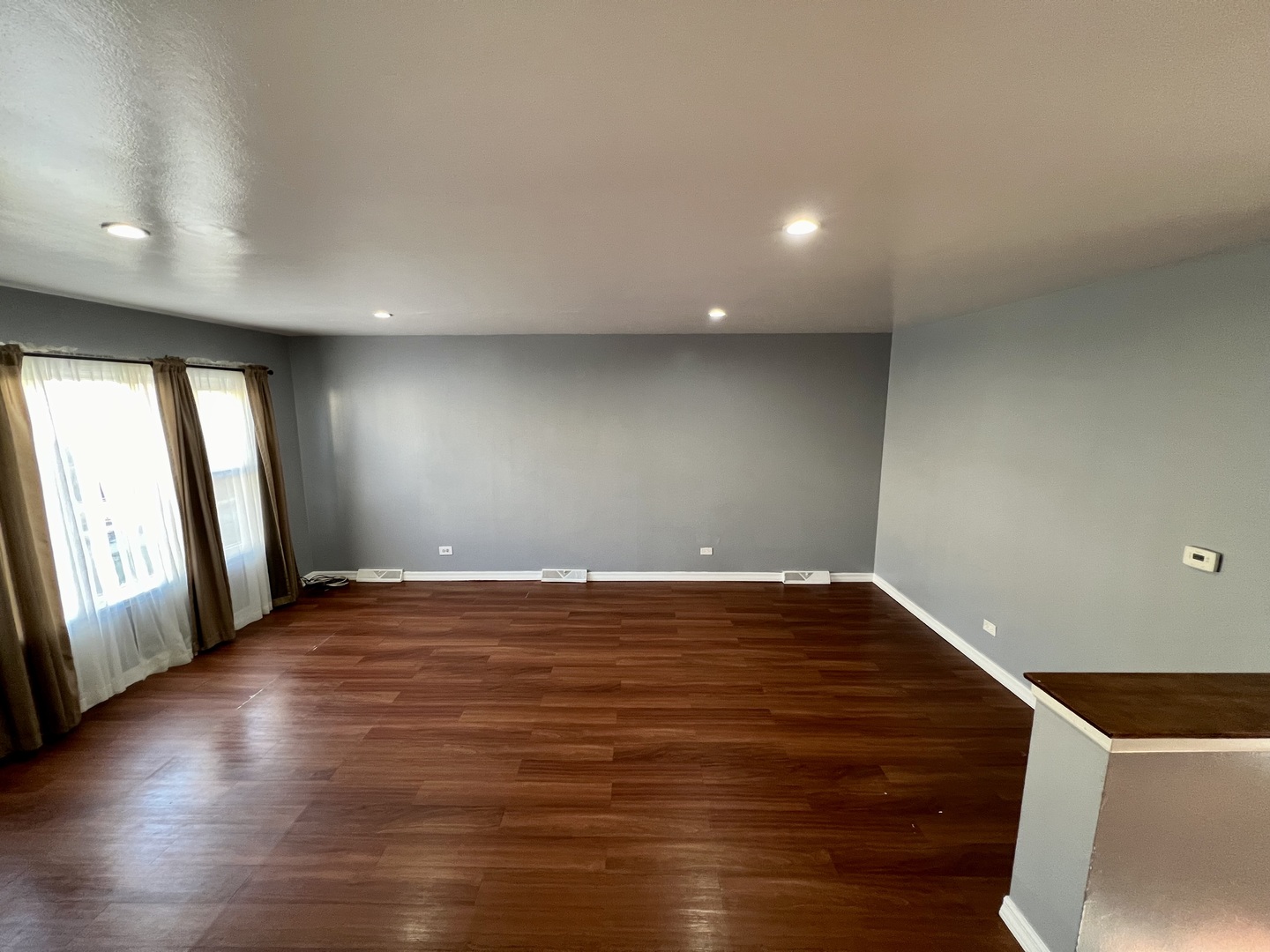 9559 Sumac Road, Unit F Des Plaines, IL 60016 - Photo 5 of 24 an empty room with wooden floor and windows