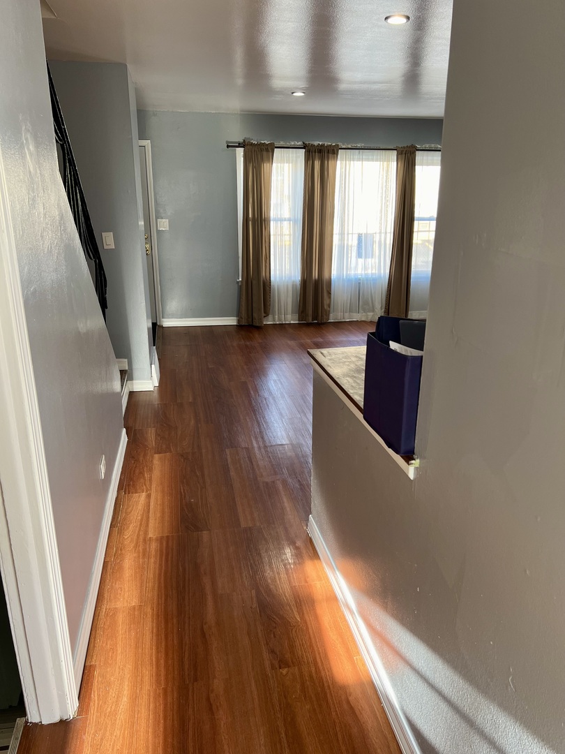 9559 Sumac Road, Unit F Des Plaines, IL 60016 - Photo 7 of 24 a view of an entryway with wooden floor